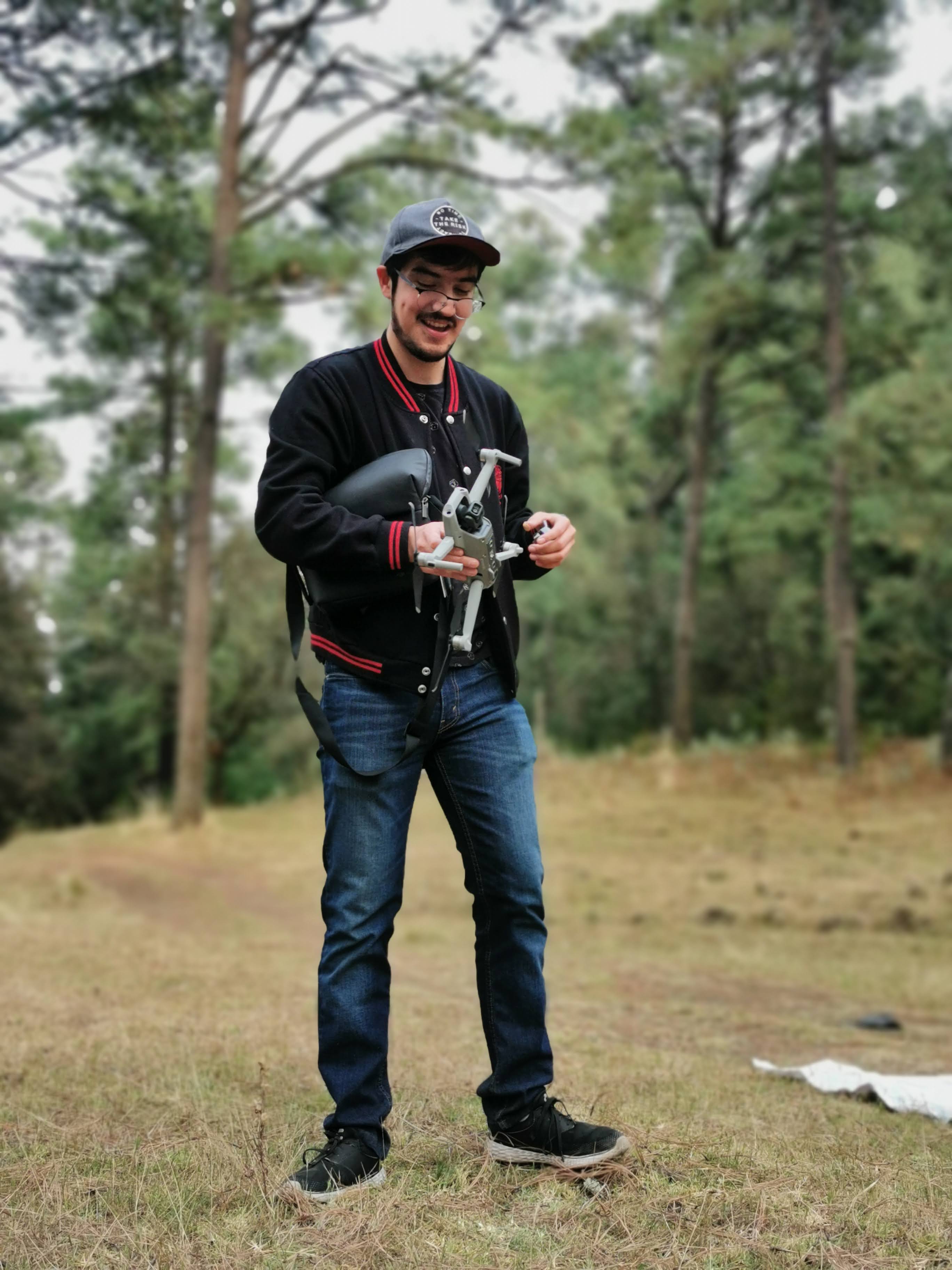 Mario Nava flying a DJI Air 2S drone in a wooded location